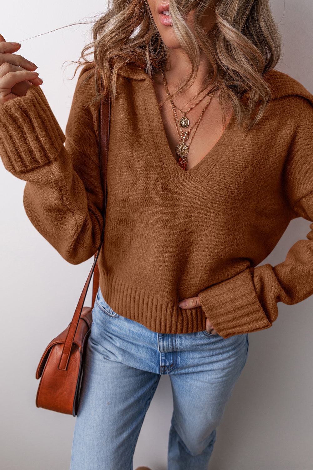 Chestnut v neck sweater for women with oversized sleeves and ribbed hem paired with blue jeans
