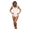 Printful chic seashell swimsuit one-piece with orange seashell pattern worn by woman in sunglasses
