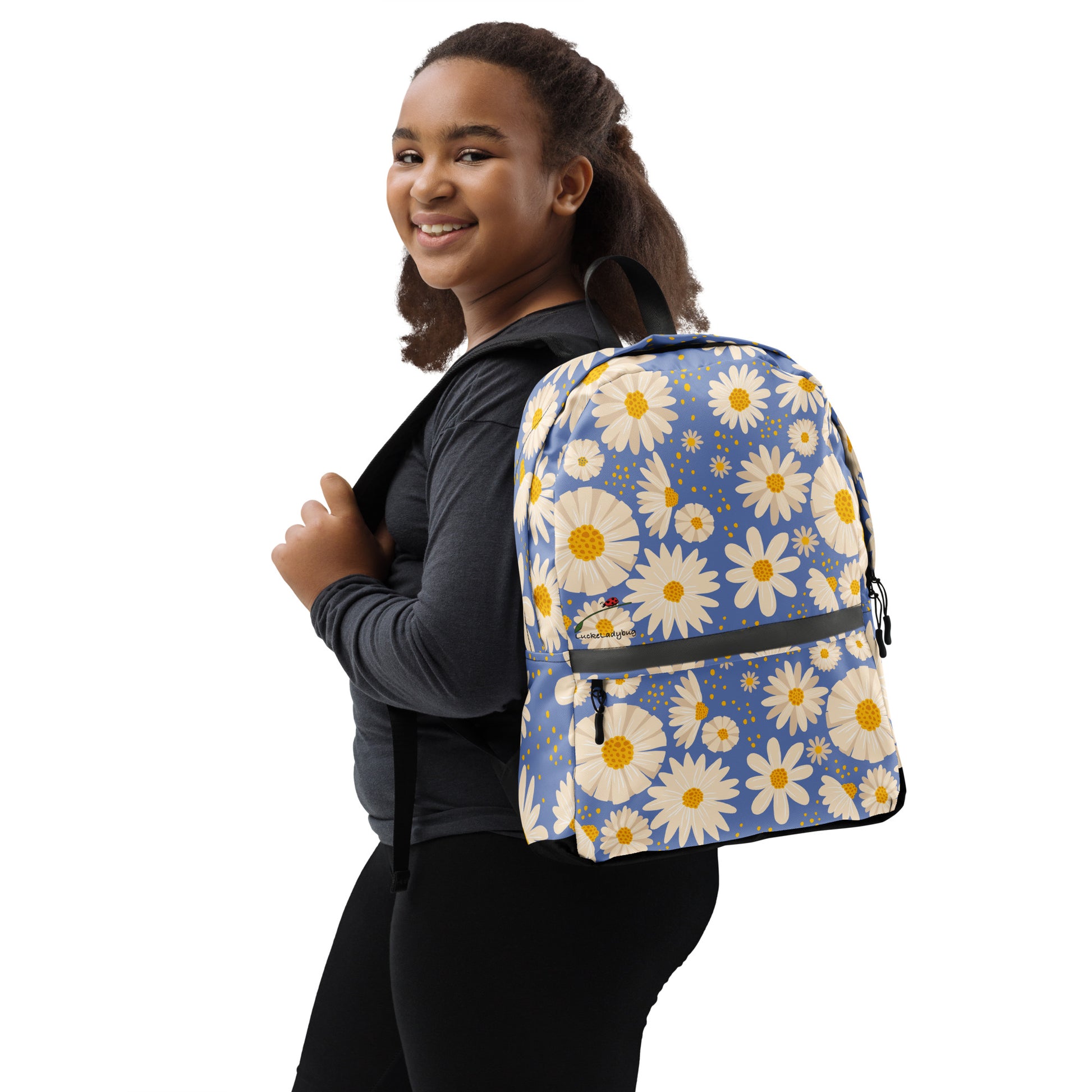 Trendy flower backpack with white and yellow daisies on blue worn by smiling woman