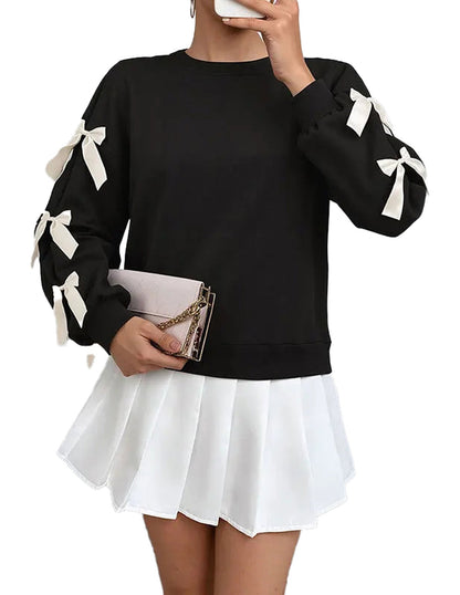 Black Christmas bow women’s sweatshirt with white bows on sleeves for festive casual wear