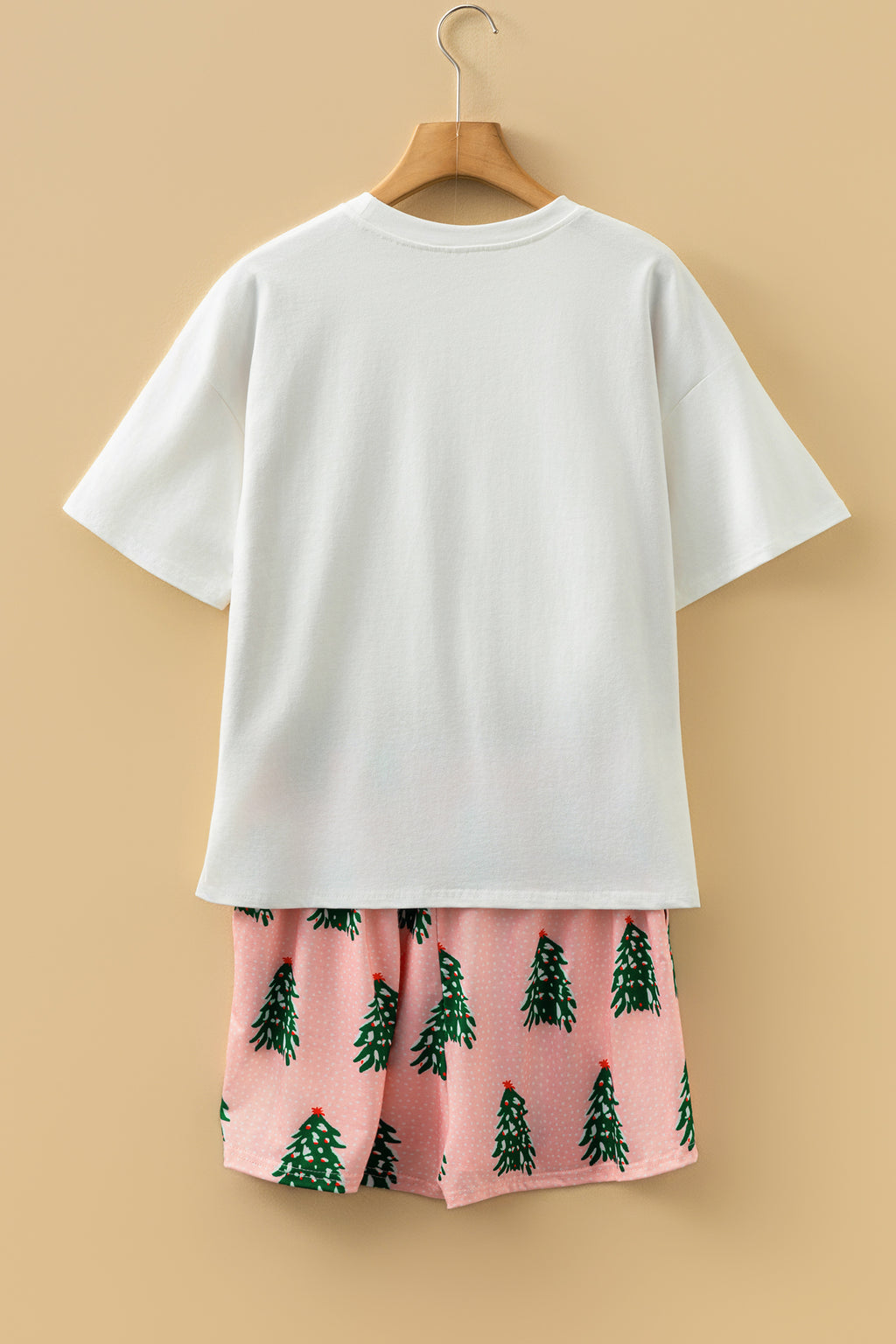 LuckeLadybug LLC Christmas pajamas set featuring pink shorts with festive green trees and a white tee