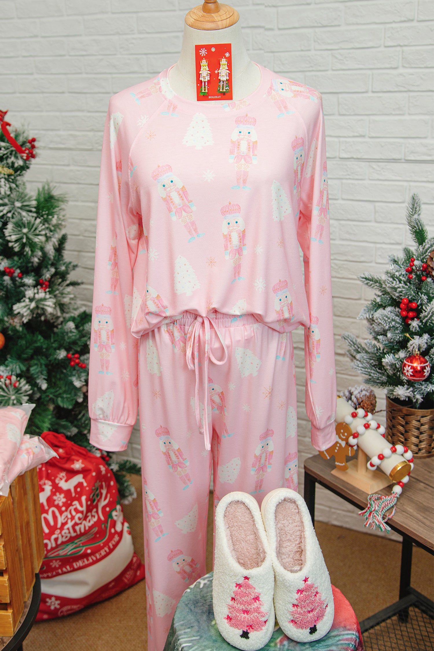 Pink Christmas pajamas featuring nutcracker and tree prints, perfect for festive holiday lounging