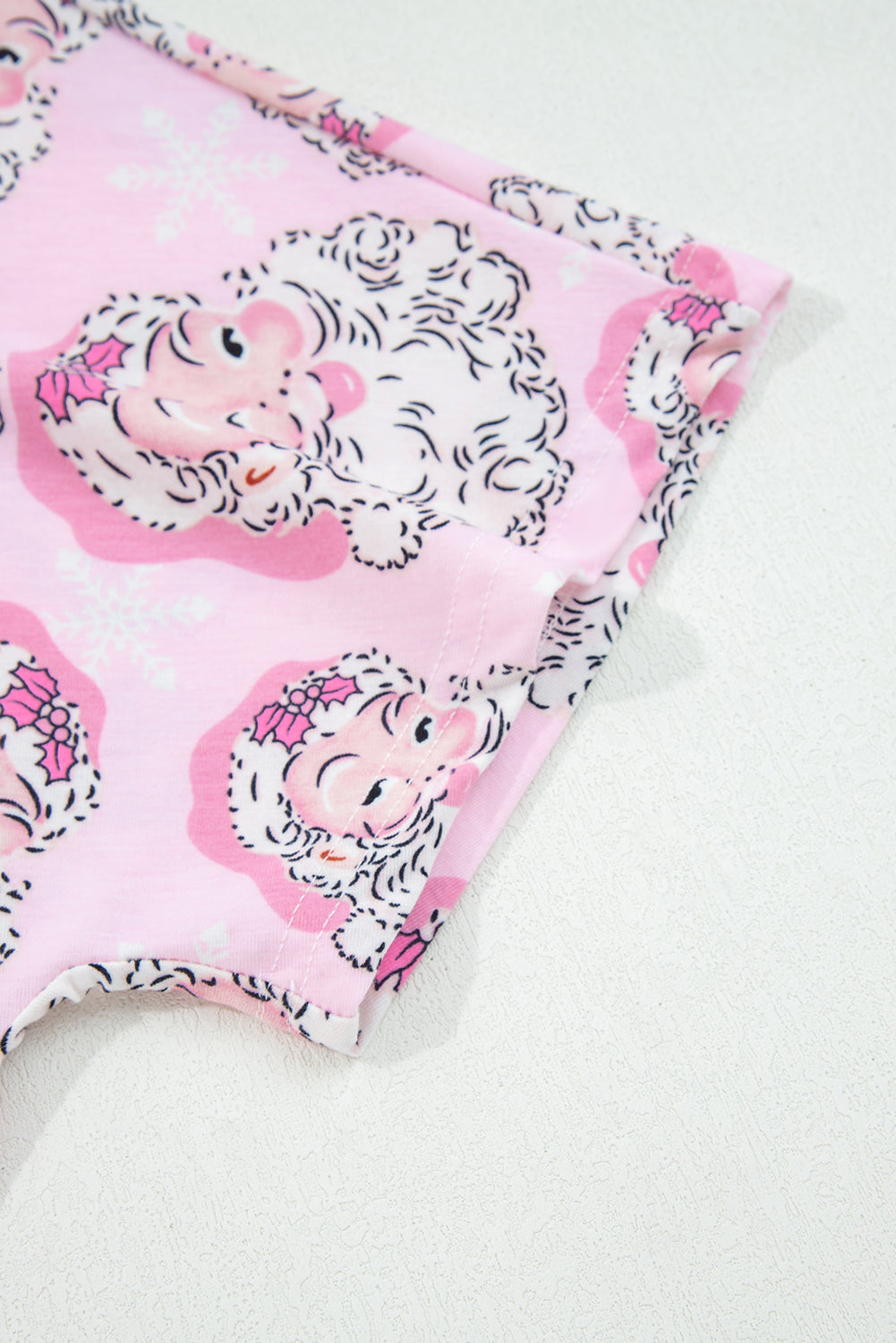 Pink Christmas pajamas with playful Santa Claus print for festive holiday wear