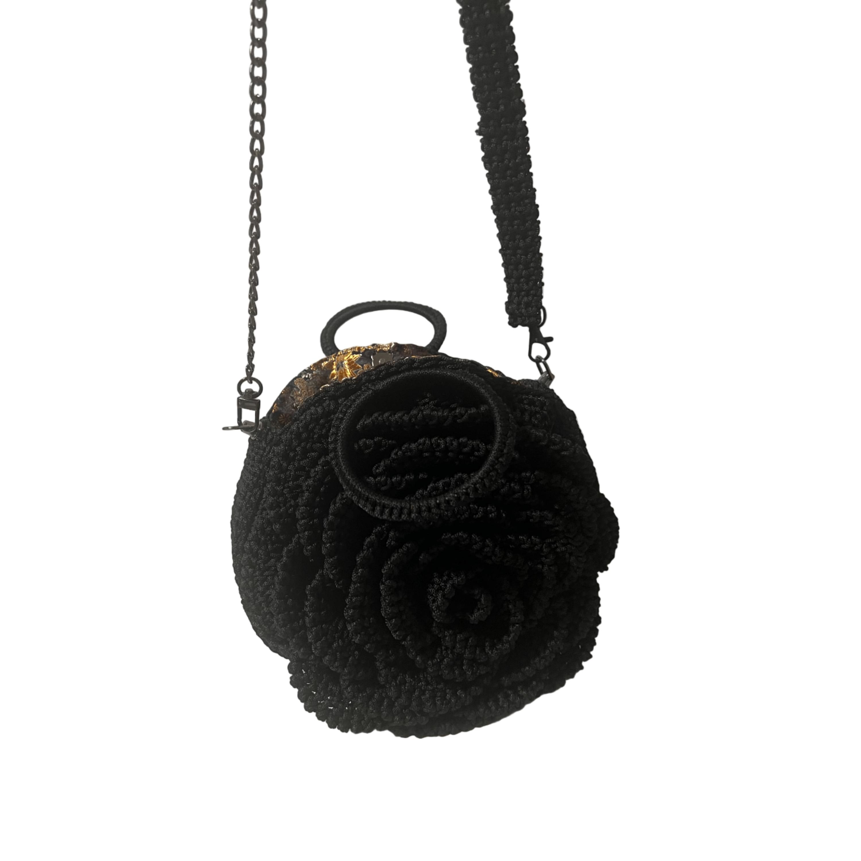 Black crossbody bag shaped like a flower, perfect for casual outings, featuring a chain strap