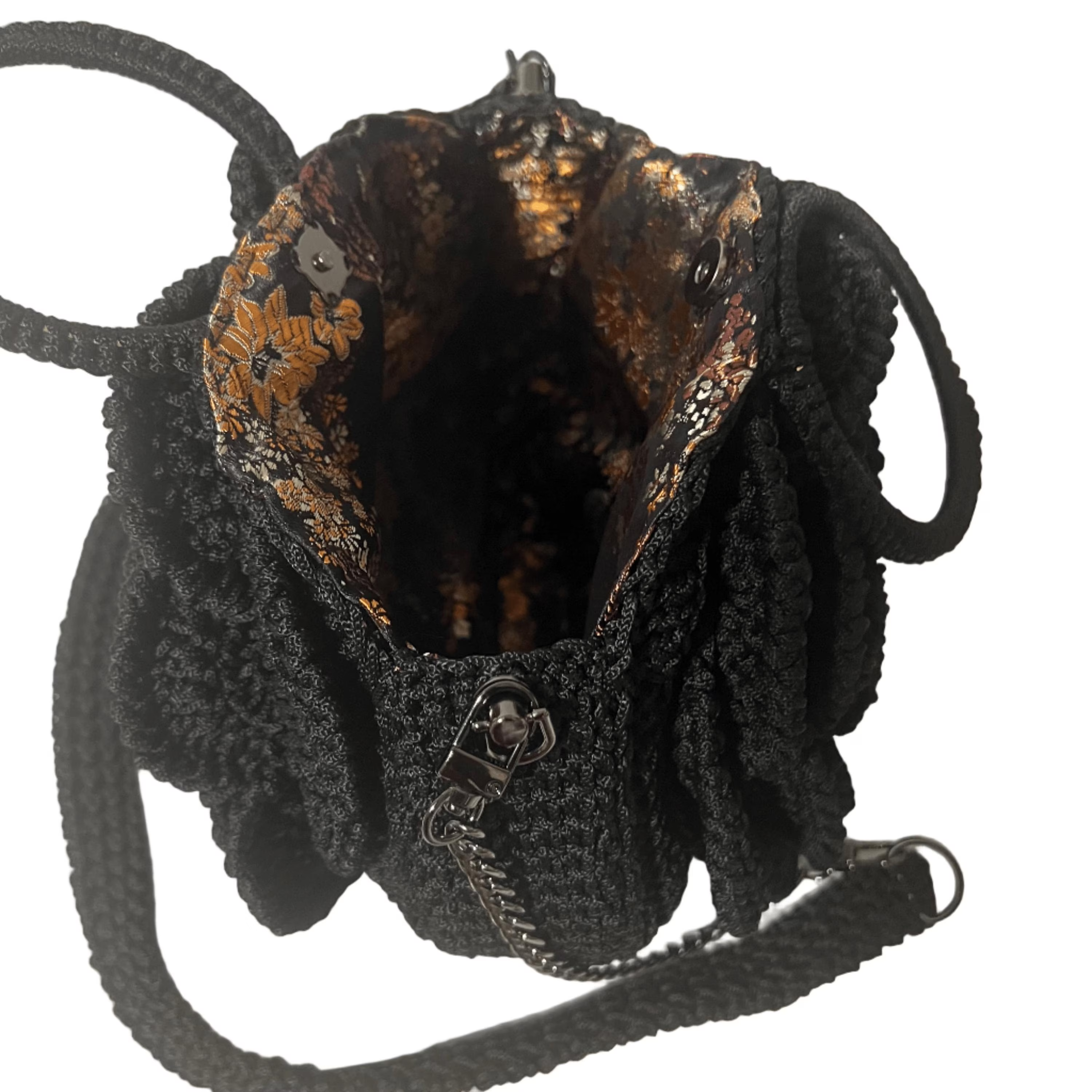 Inside view of a black ThreadsByHannah crossbody bag featuring a stylish coach floral bag design