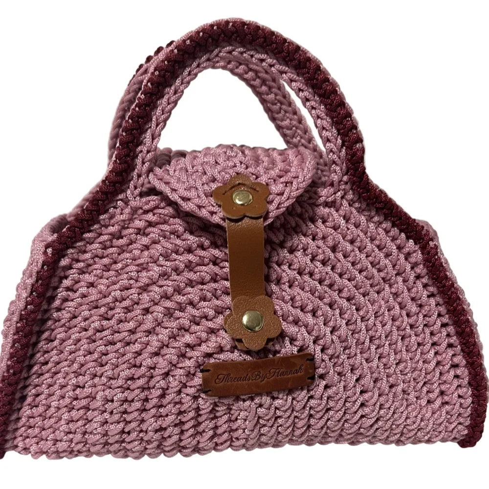 Handcrafted pink coach handbag pink made with braided material and leather accents for stylish outings