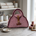 Handcrafted pink clutch from ThreadsByHannah resembling a coach handbag pink for stylish occasions