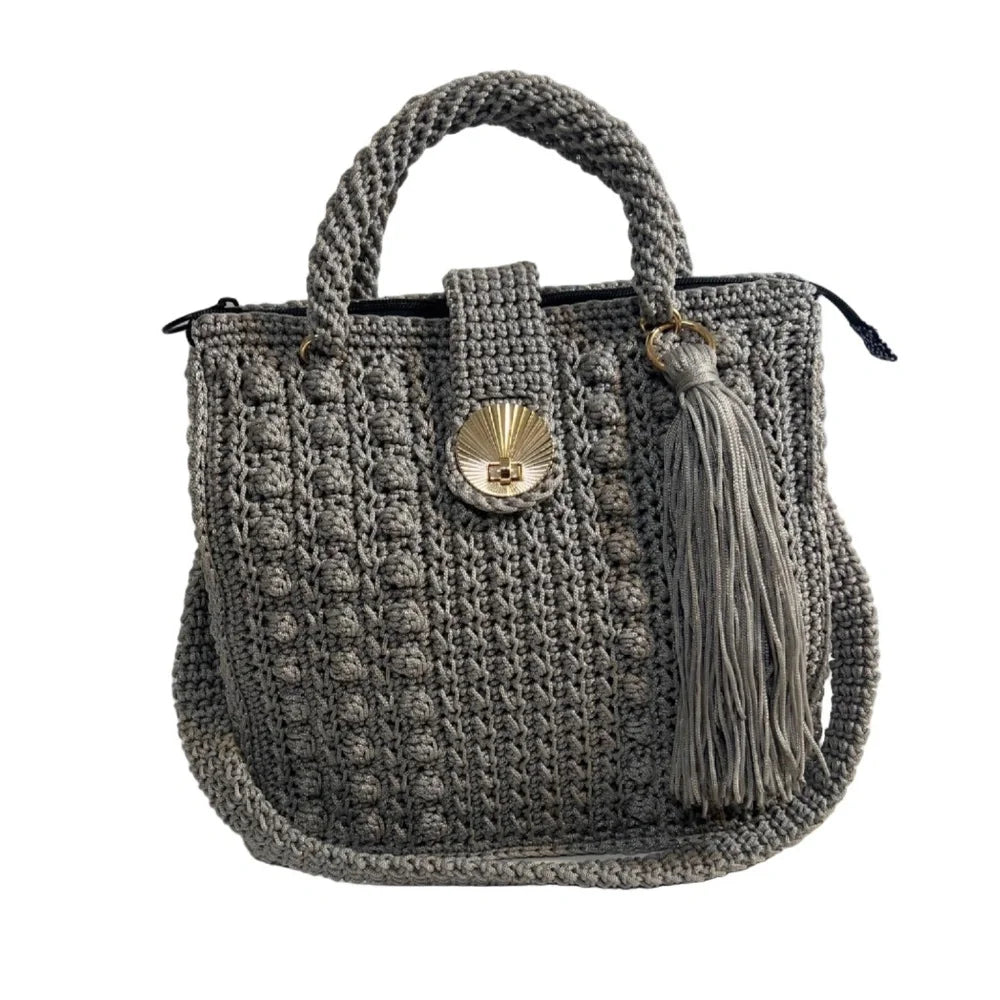 Stylish gray coach purse shoulder bag with textured crochet design and decorative tassel