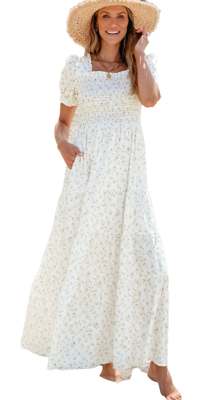 LuckeLadybug white floral maxi dress with smocked bodice puff sleeves side pockets worn by woman on beach