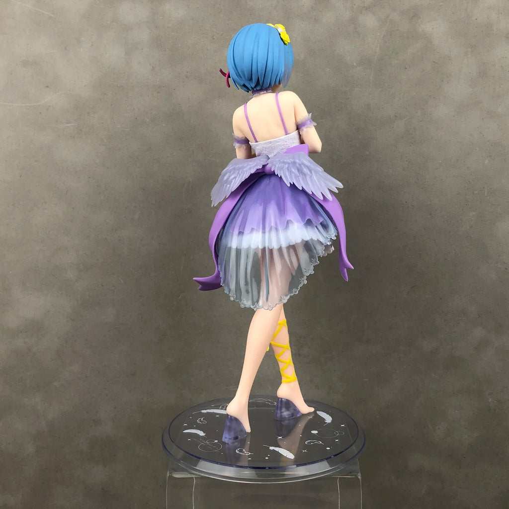 Back view of a detailed collectible figure in a colorful dress by LuckeLadybug LLC