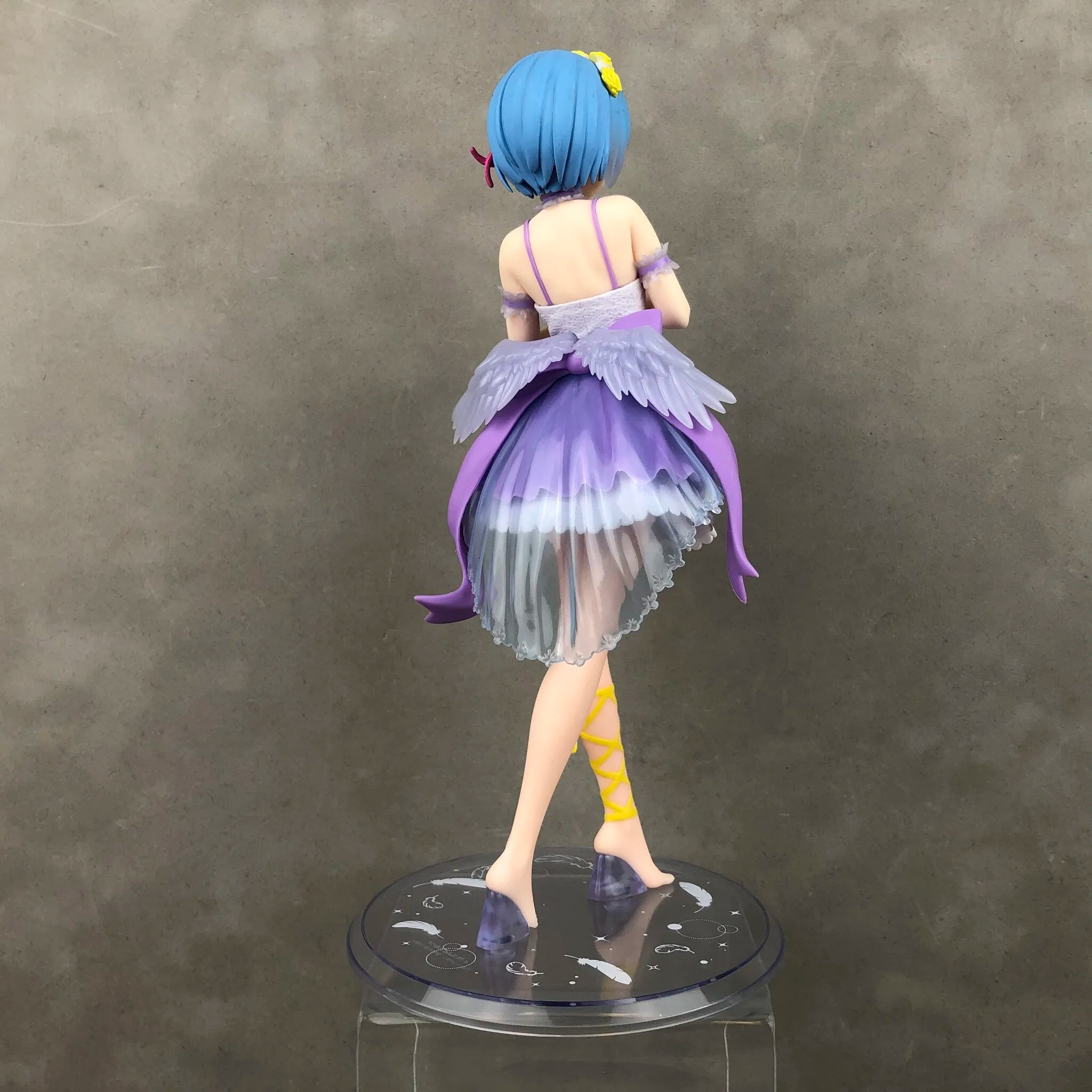 Back view of a detailed collectible figure in a colorful dress by LuckeLadybug LLC