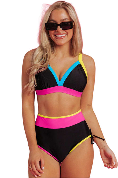 Woman wearing color block high waist bikini with black pink blue and yellow accents by LuckeLadybug LLC