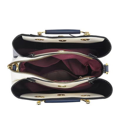 Inside view of LuckeLadybug LLC colorblock top handle satchel featuring multiple compartments and a zippered pocket