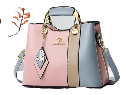Stylish colorblock top handle satchel featuring a chic design and removable charm for everyday use