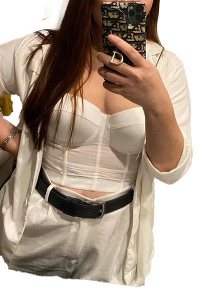 Stylish model wearing a plus size mesh corset top paired with a light jacket and belt