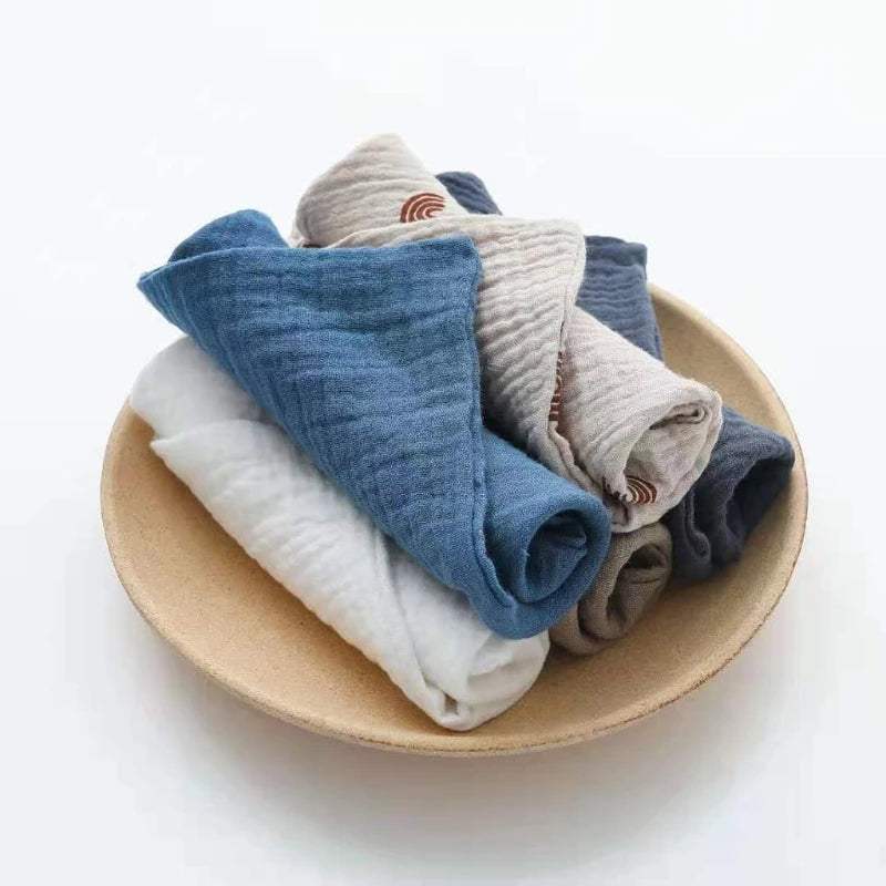 Set of soft cotton washcloths in various colors neatly arranged in a bowl