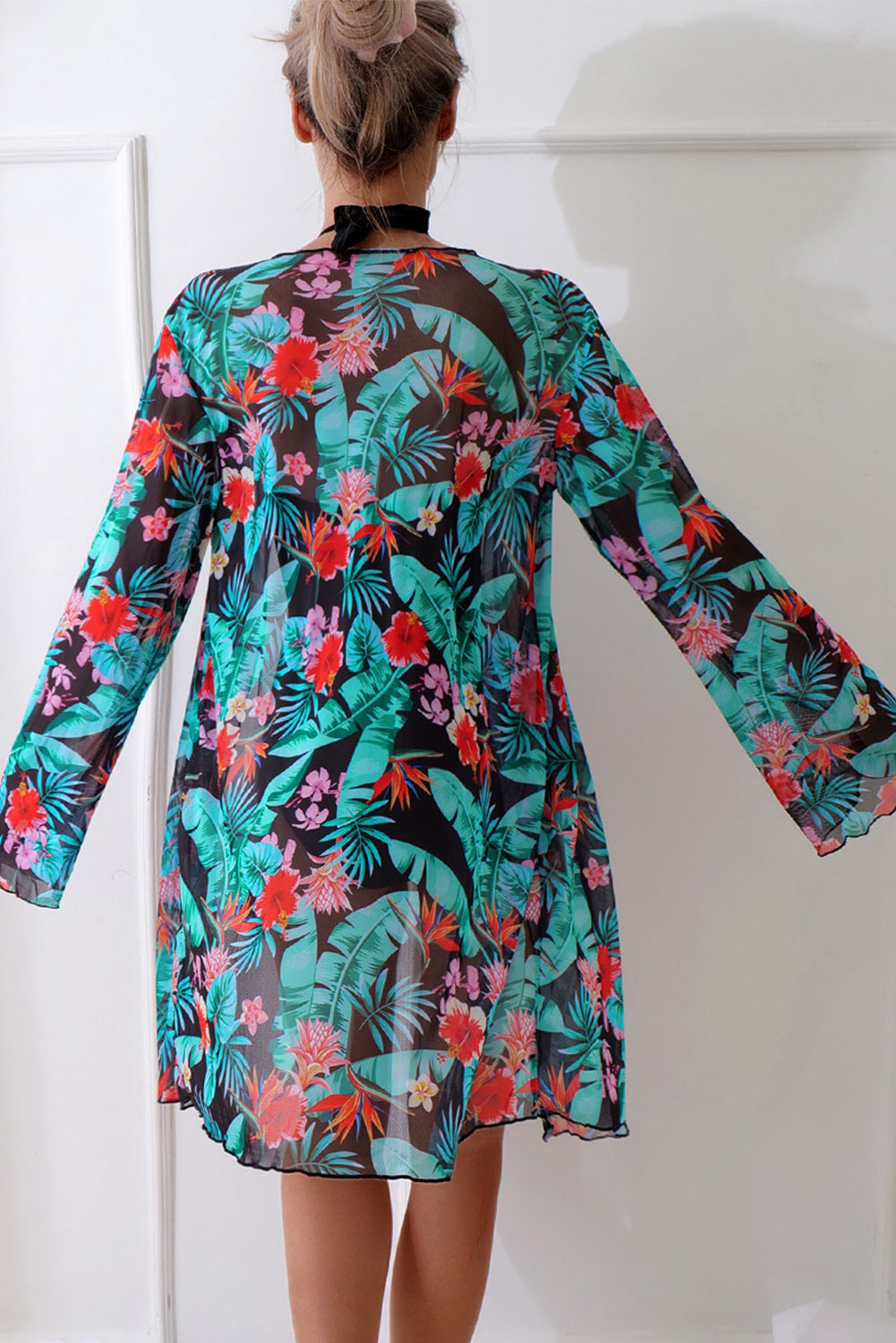 Colorful floral one-piece cover up for the beach with flowing sleeves and a relaxed fit