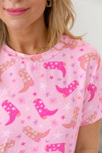 Cute pink pattern t-shirt featuring cowboy western boots and star designs, perfect for casual wear
