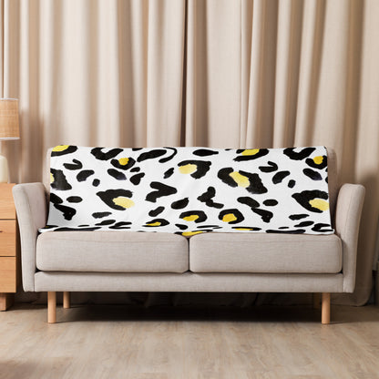 LuckeLadybug sherpa blanket with cozy animal print bedding draped over beige sofa in living room