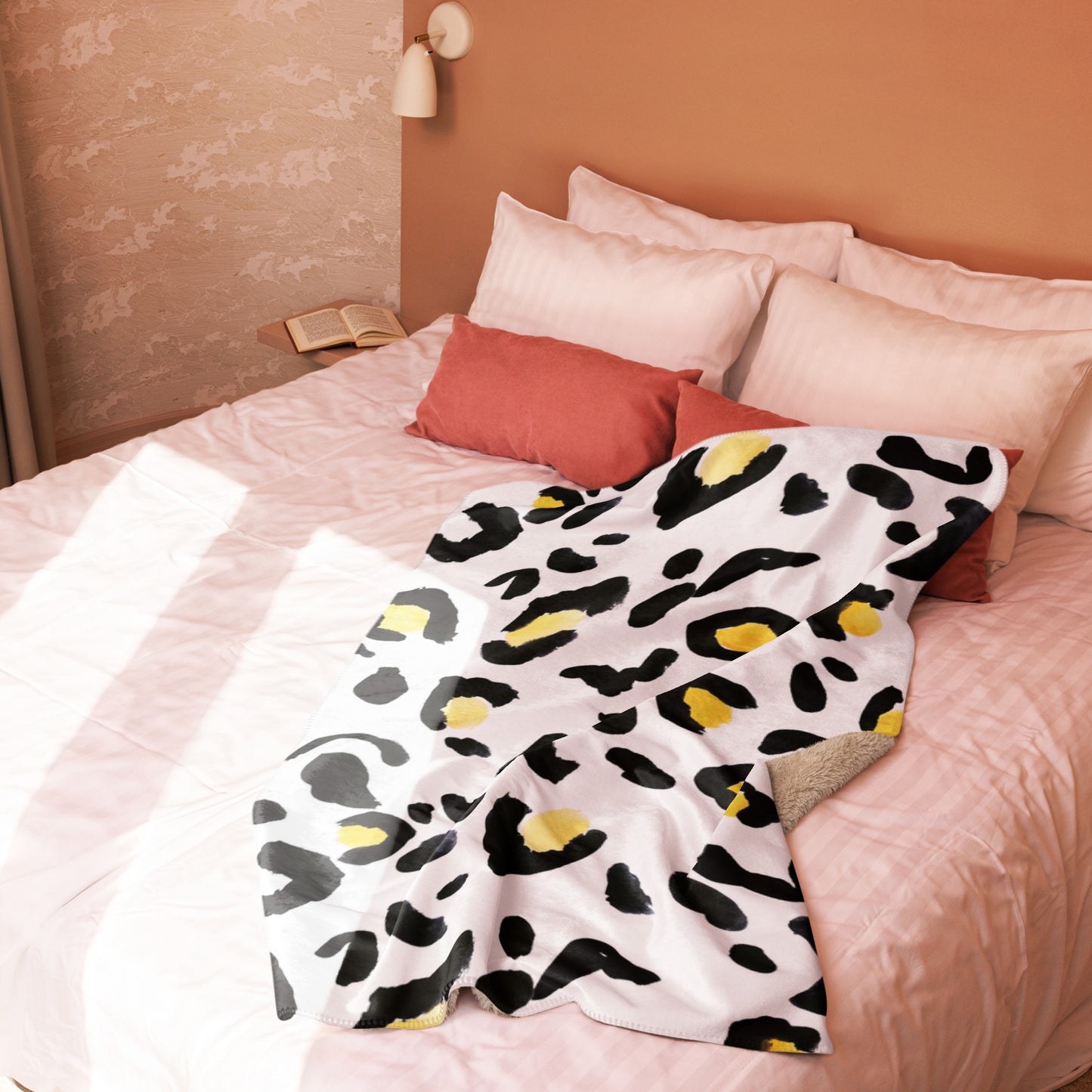 LuckeLadybug sherpa blanket with cozy animal print bedding draped on a light pink bed