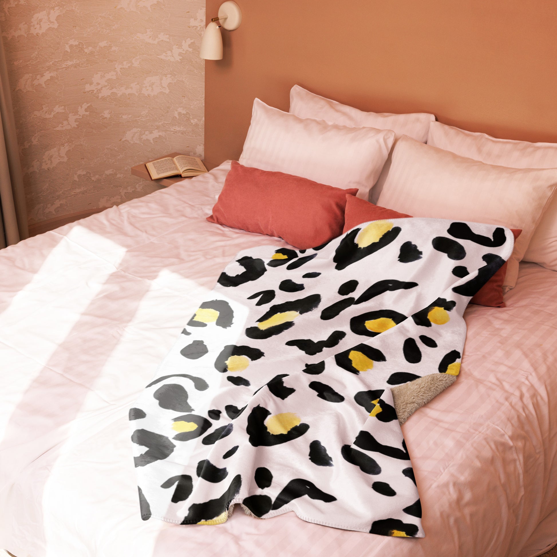 LuckeLadybug sherpa blanket with cozy animal print bedding draped on a light pink bed