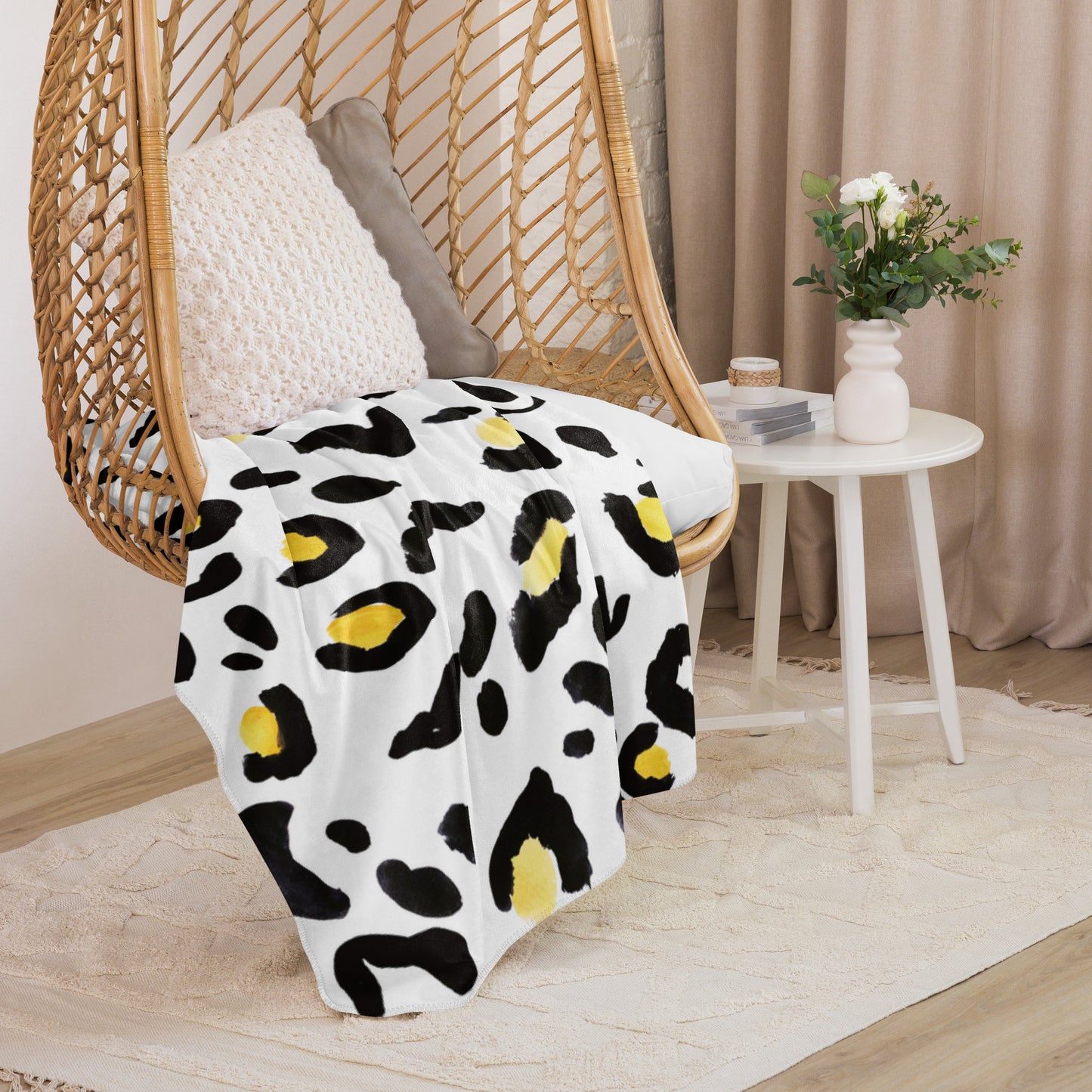 LuckeLadybug sherpa blanket with cozy animal print bedding draped over a wicker chair in a modern room