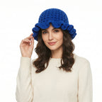 Crochet hat with ruffle in blue, featuring a stylish design and a comfortable fit