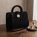 Stylish black crossbody women's handbag with textured design and a stylish tassel detail