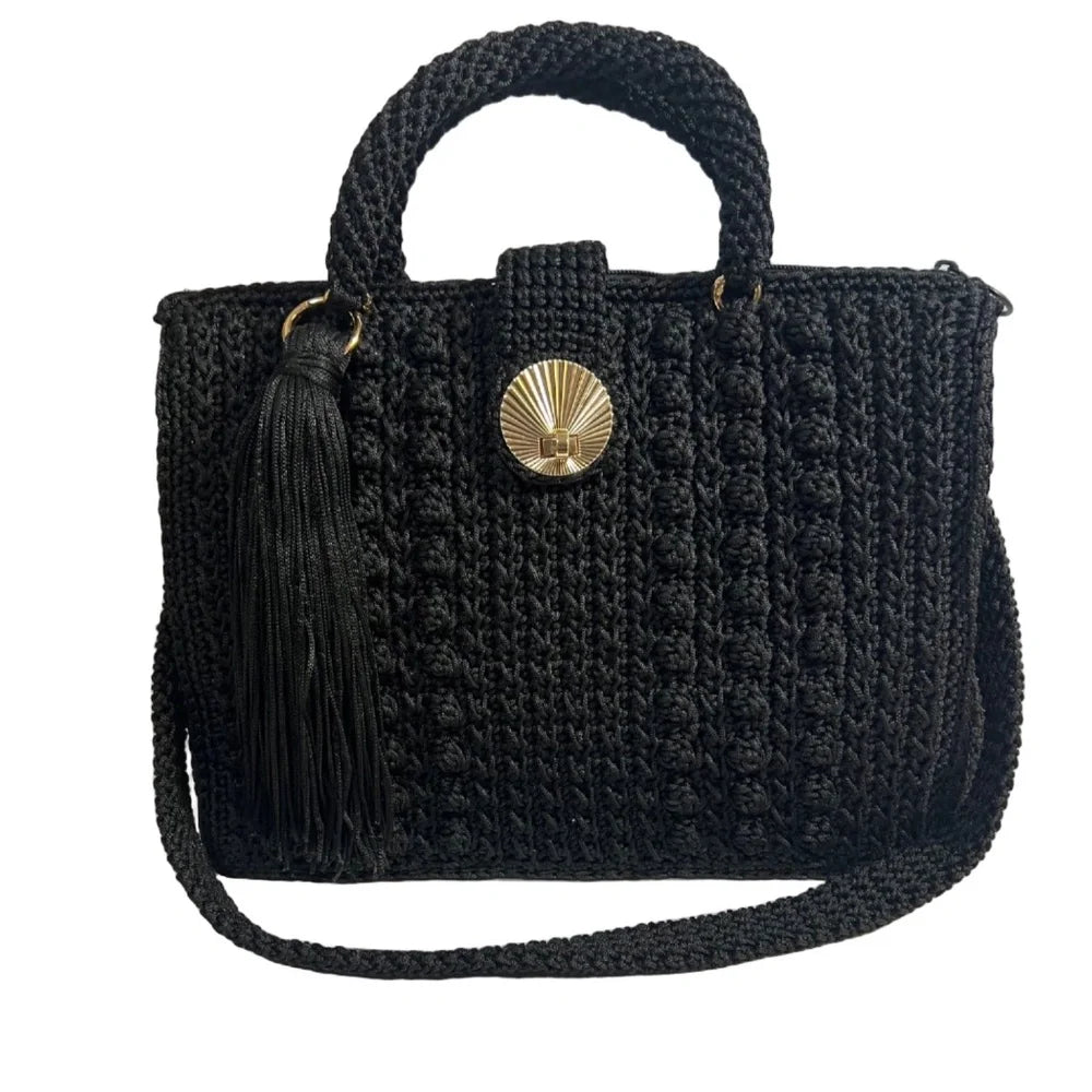 Black crochet crossbody women's handbag with a decorative tassel and stylish button closure
