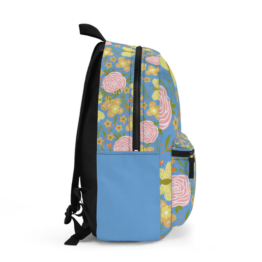 Side view of a custom butterfly and flower backpack with vibrant floral patterns and a blue bottom panel