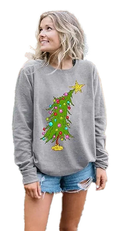 Woman wearing a grey sweatshirt with a colorful Christmas tree design, ideal for cute Christmas sweatshirts for women