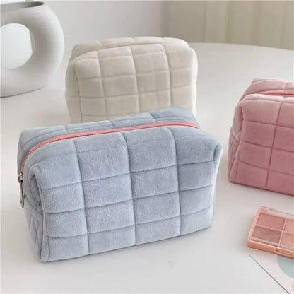 Cute plush makeup bag in soft pastel colors with a quilted design for stylish storage