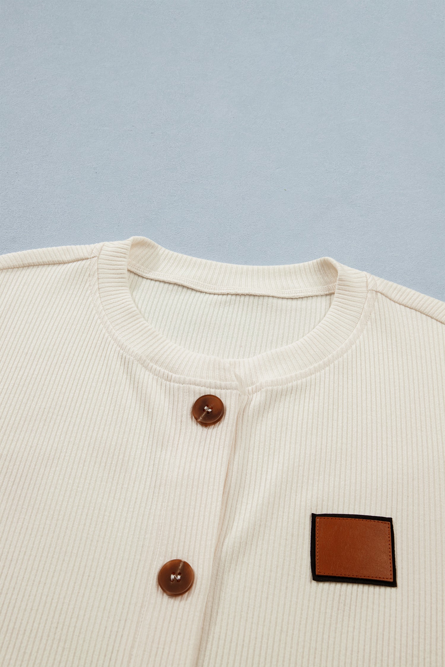 Cream-colored denim shirt by LuckeLadybug LLC with ribbed texture and button detail