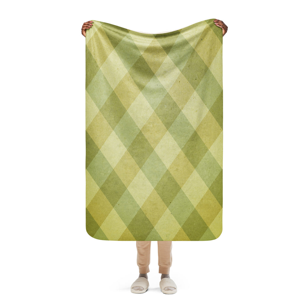 LuckeLadybug Sherpa blanket with green diamond pattern bedding held by person wearing slippers