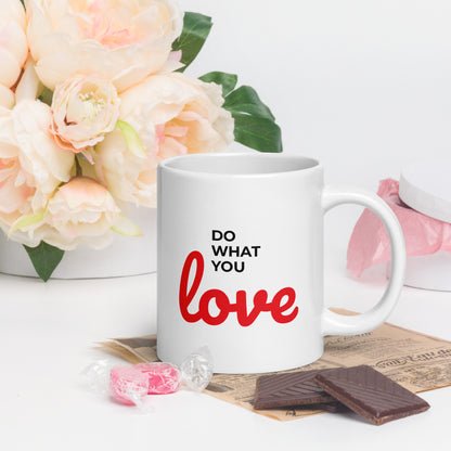 LuckeLadybug do what you love coffee mug with white ceramic and red black text next to flowers and chocolates