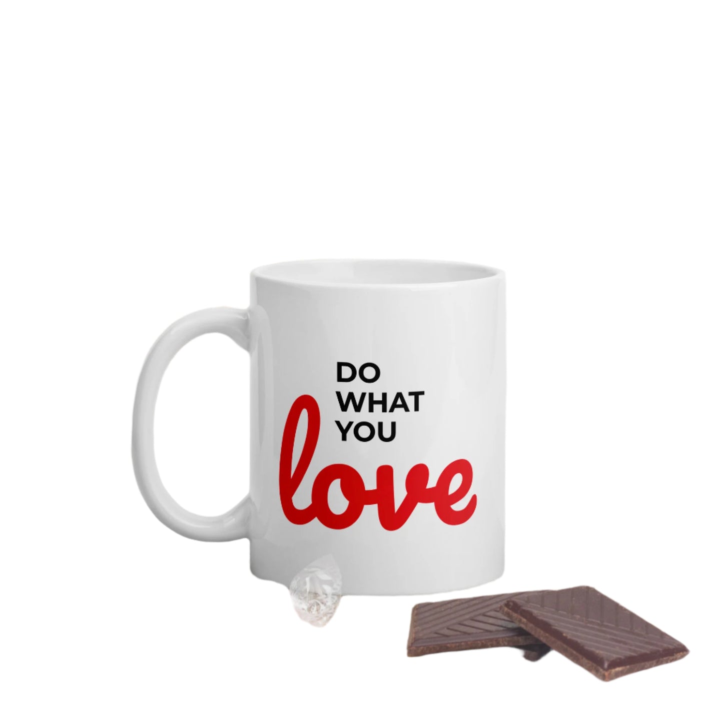 White do what you love coffee mug with black and red text beside chocolate pieces