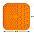Orange dog enrichment toy pad with textured surfaces for stimulating playtime and feeding