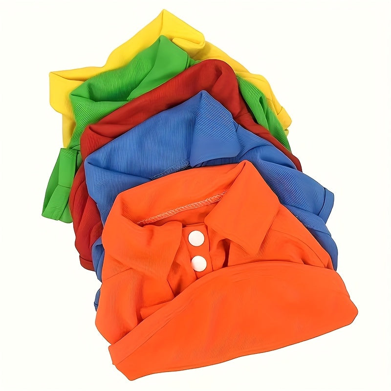 Variety of colorful dog polo shirts for small dogs stacked in vibrant hues of red, blue, orange, yellow, and green