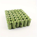 Pack of eco-friendly green poop bags for dog with paw print design, perfect for pet owners