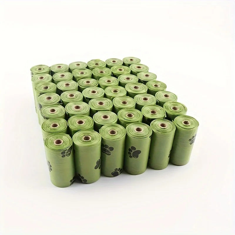 Pack of eco-friendly green poop bags for dog with paw print design, perfect for pet owners