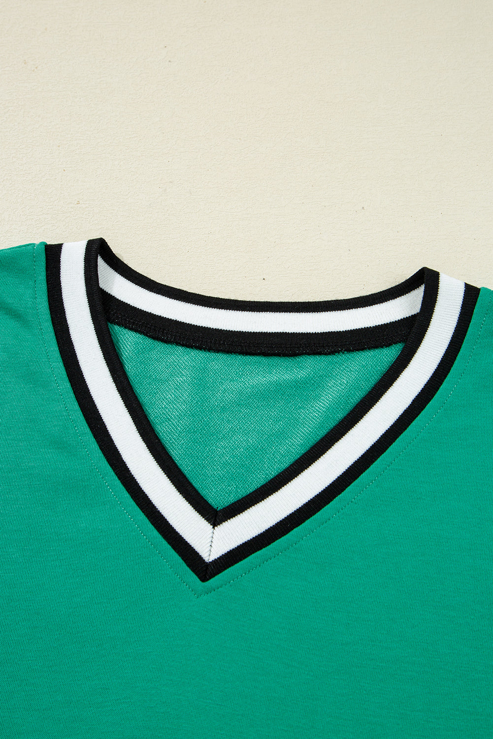 Green T-shirt with V-neck design, perfect for styling as a dress from t-shirt