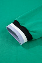 Close-up of green t-shirt sleeve featuring a striped cuff, perfect for creating a dress from t-shirt