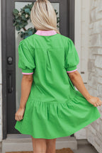 Bright green mini dress from LuckeLadybug LLC with pink collar and puff sleeves, perfect for casual outings