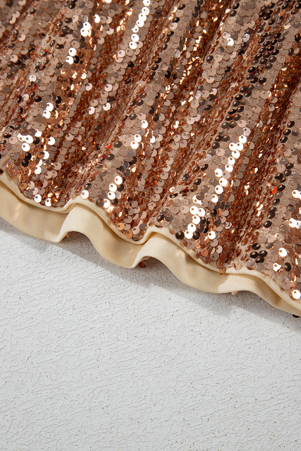 Shiny rose gold sequins on a mini dress by LuckeLadybug LLC with a ruffled hem design