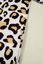 Close-up of a dress with leopard print featuring bold black and tan patterns on a light background