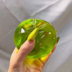 Green dumplings squishy toy in hand, perfect for stress relief and sensory play