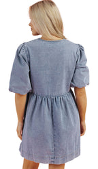 Back view of a dusk blue denim dress with puff sleeves and a cinched waist by LuckeLadybug