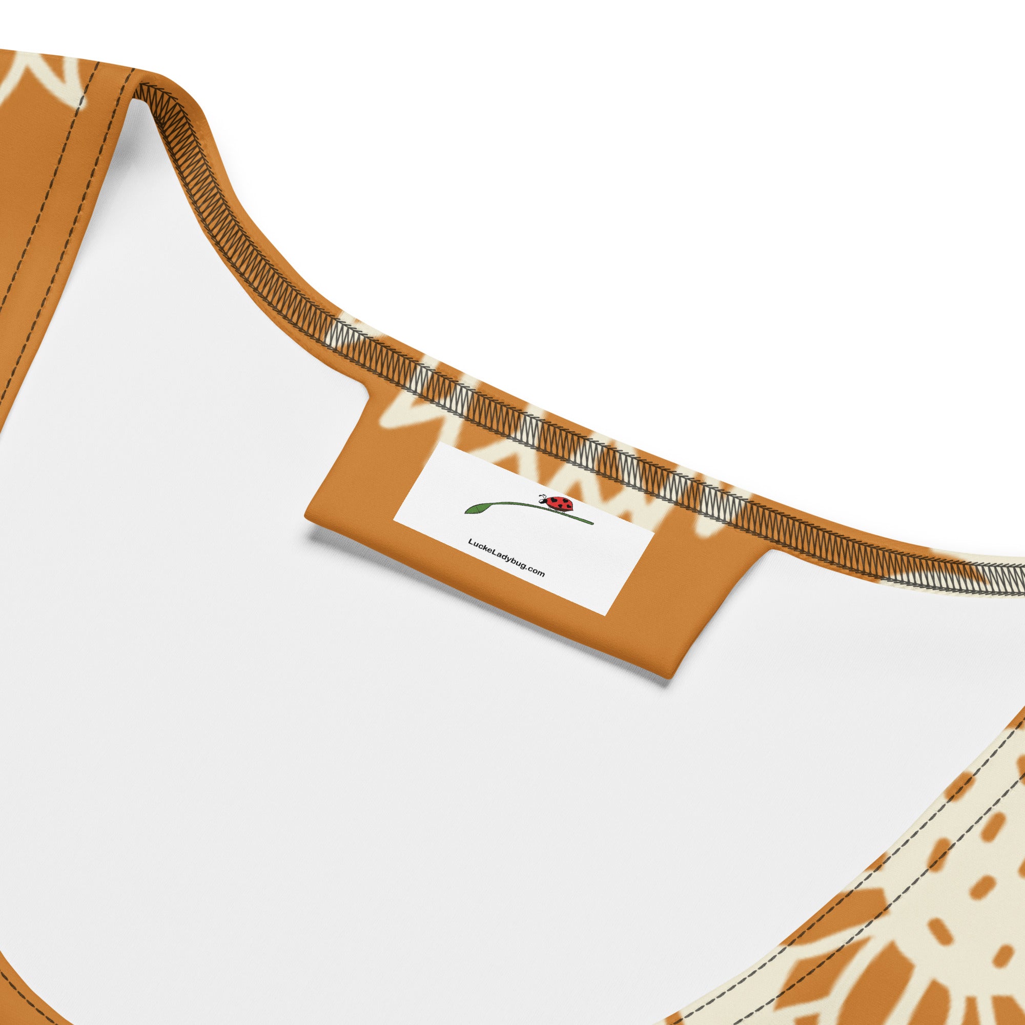 Close-up of LuckeLadybug label on elegant floral print bodycon dress with brown and beige stitching
