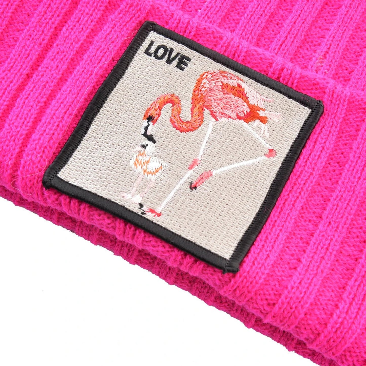 Pink embroidered beanies for women featuring a flamingo patch with the word Love