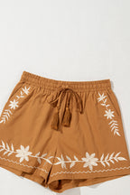 LuckeLAdybug LLC embroidered shorts in brown with white floral design and adjustable tassel tie